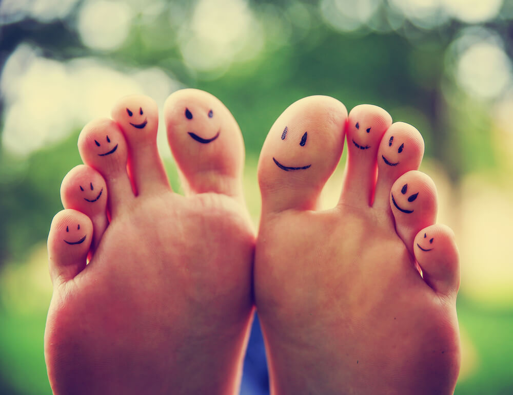 Feet with faces drawn on toes