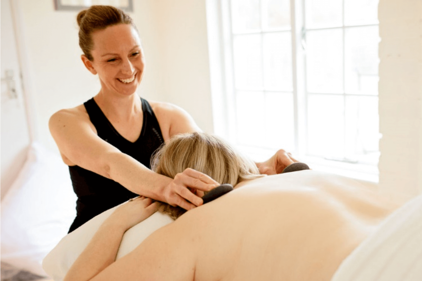 Caroline giving a hot stones massage